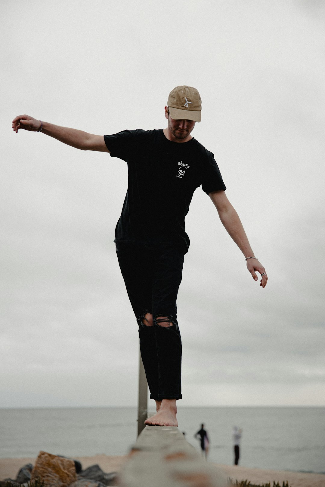 man in black crew neck t-shirt and black pants standing on white clouds during daytime