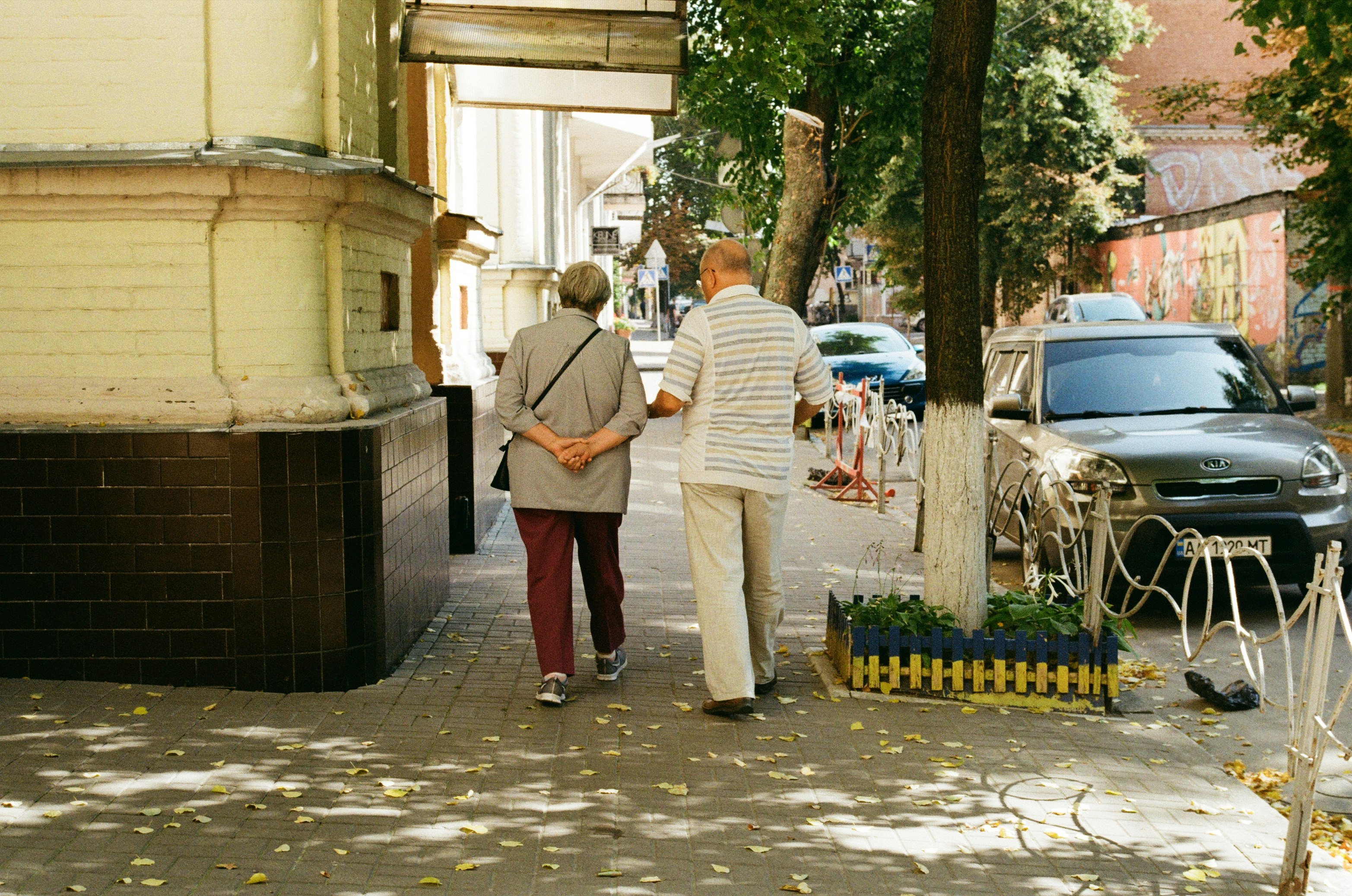 man in white dress shirt and red pants standing near man in white dress shirt