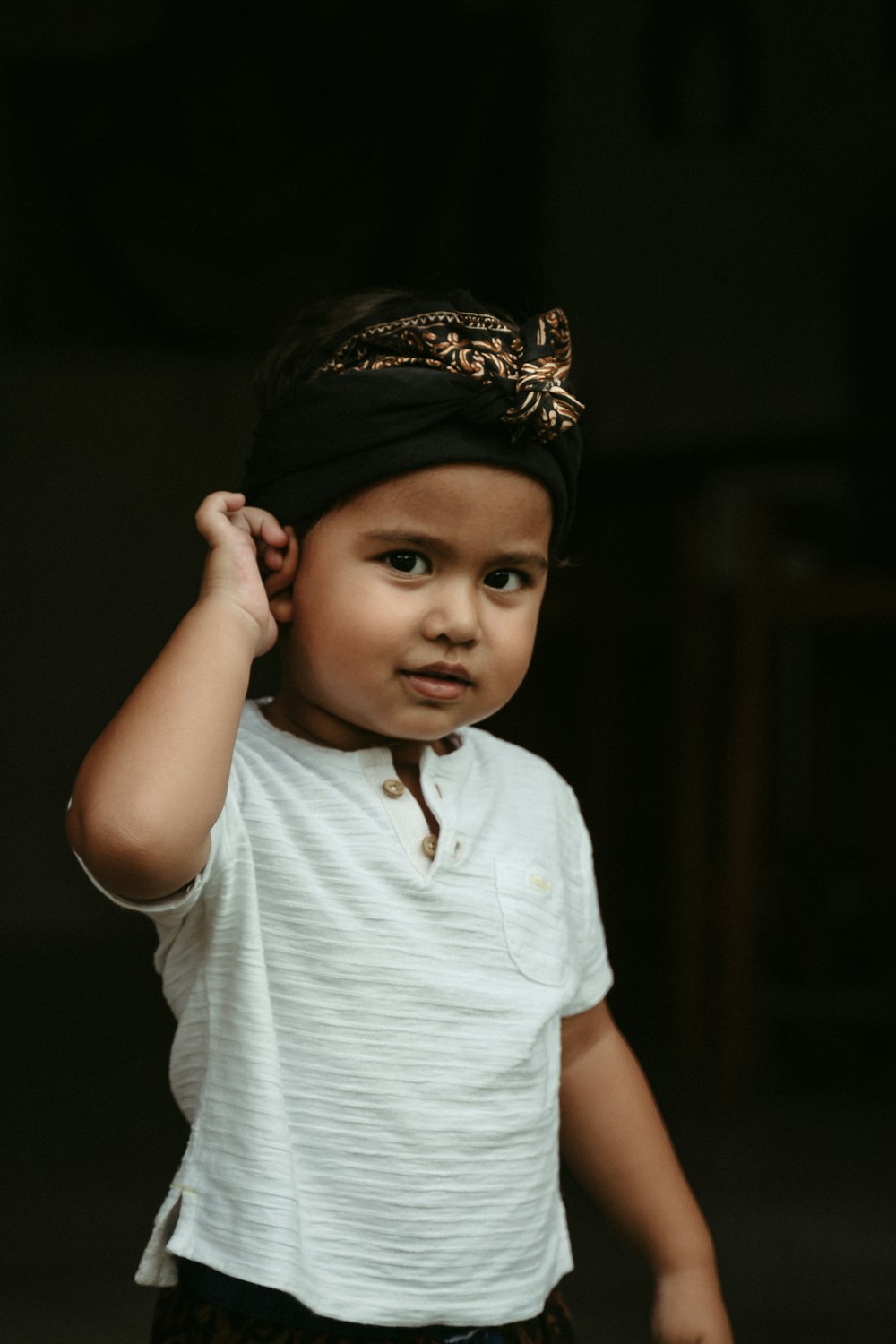 girl in white crew neck t-shirt and black floral headband