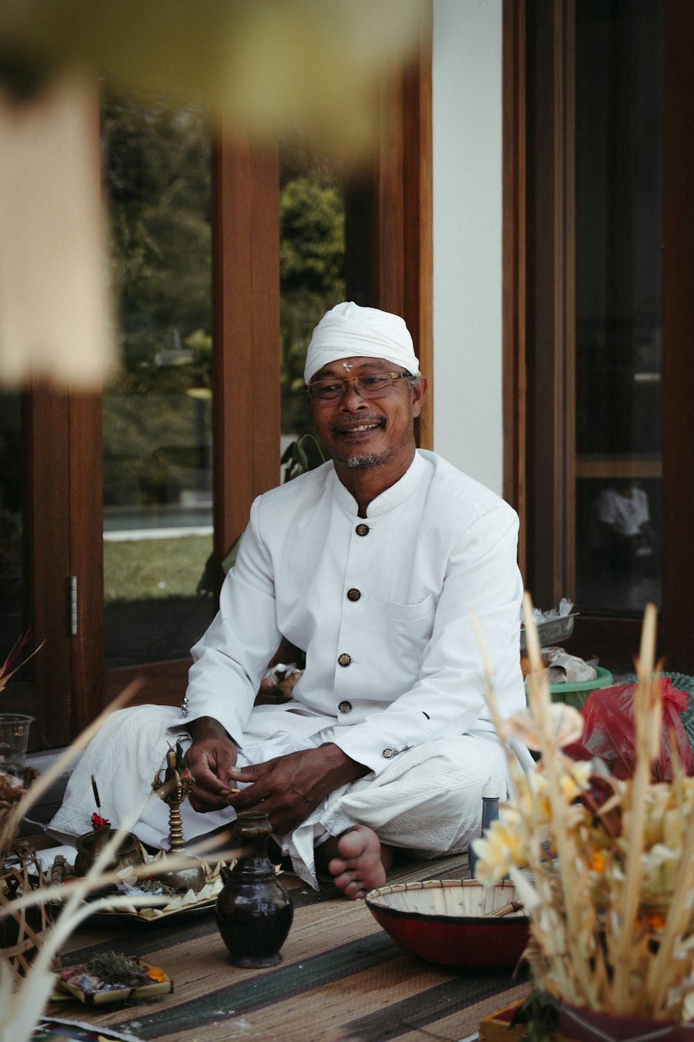 man in white thobe sitting on chair