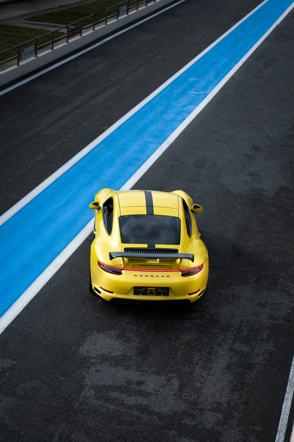 yellow porsche 911 on road