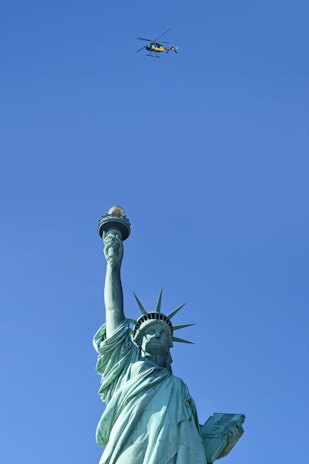 The Statue of Liberty framed by a clear blue sky, symbolizing opportunity in the USA.