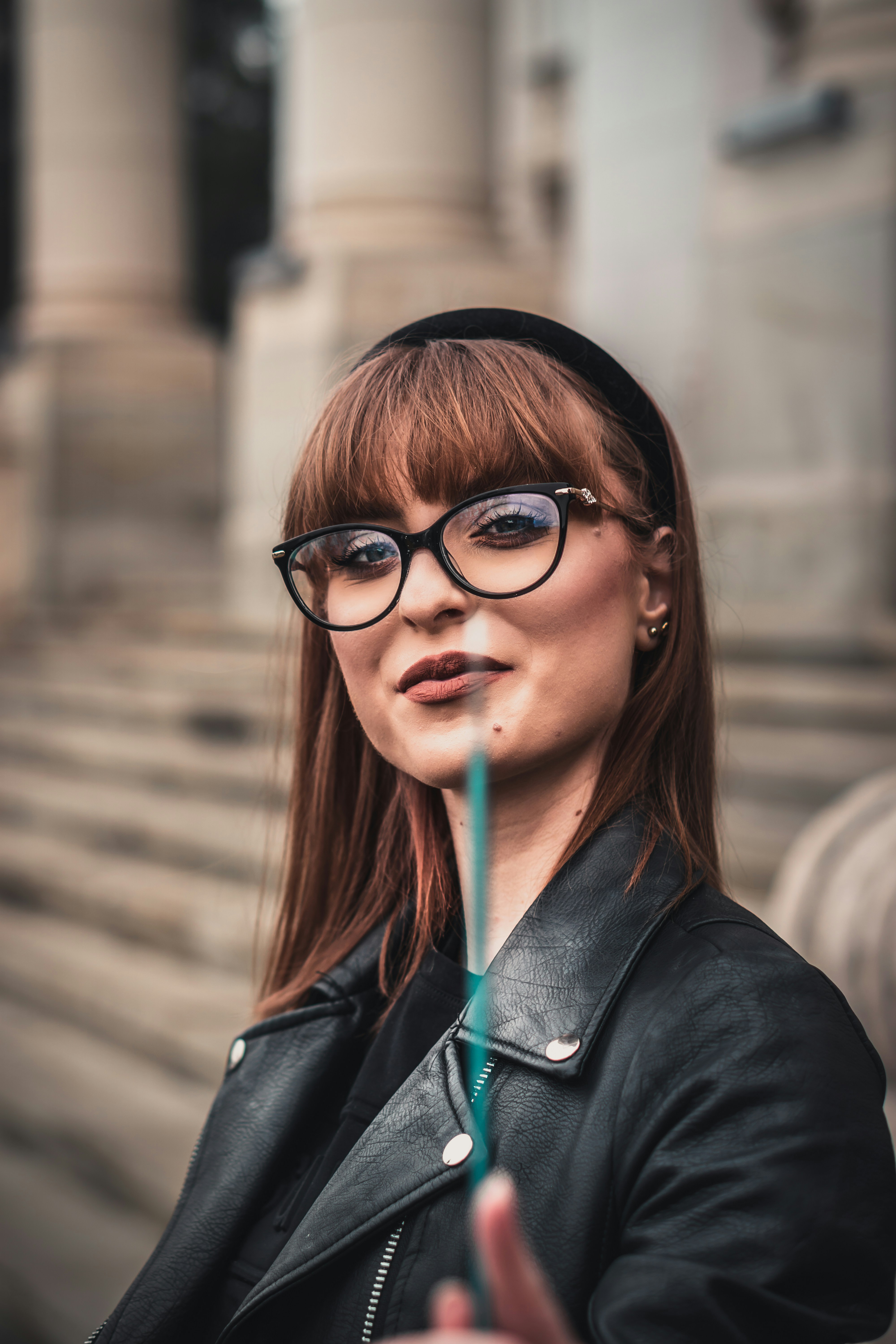 woman in black leather jacket wearing black framed eyeglasses