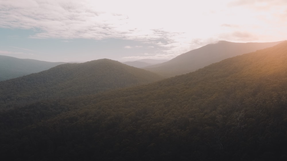 green mountains under white clouds during daytime