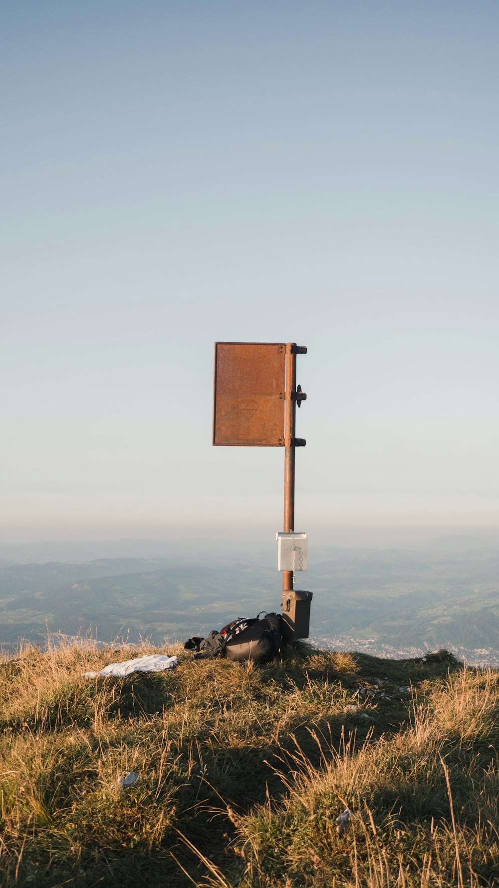 brown wooden signage on top of hill during daytime