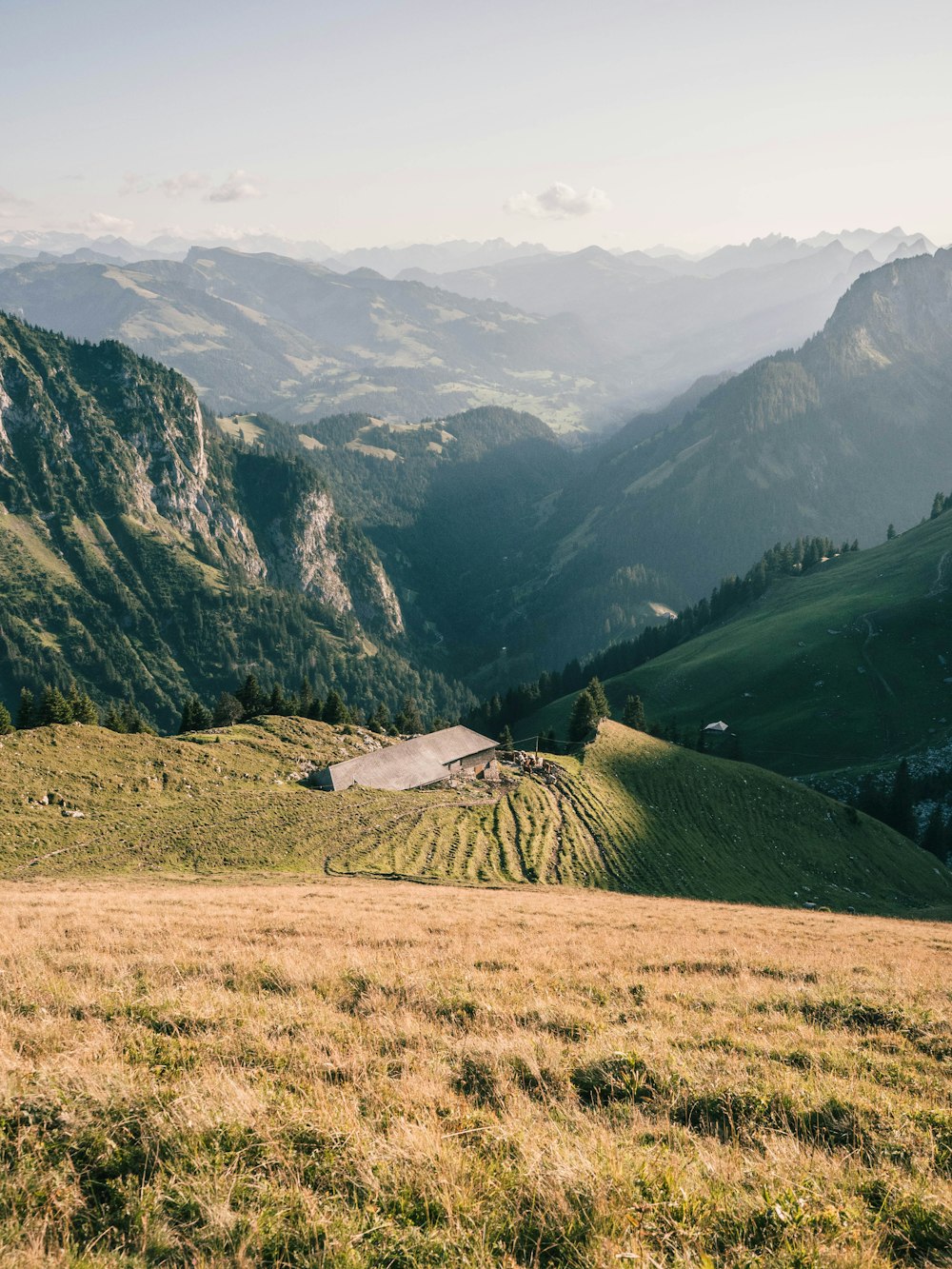 green grass field near mountain during daytime