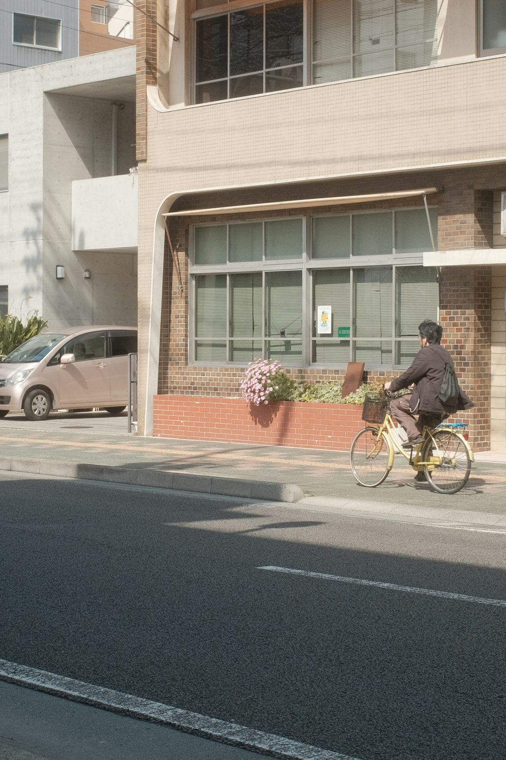 man in black jacket riding bicycle on road during daytime