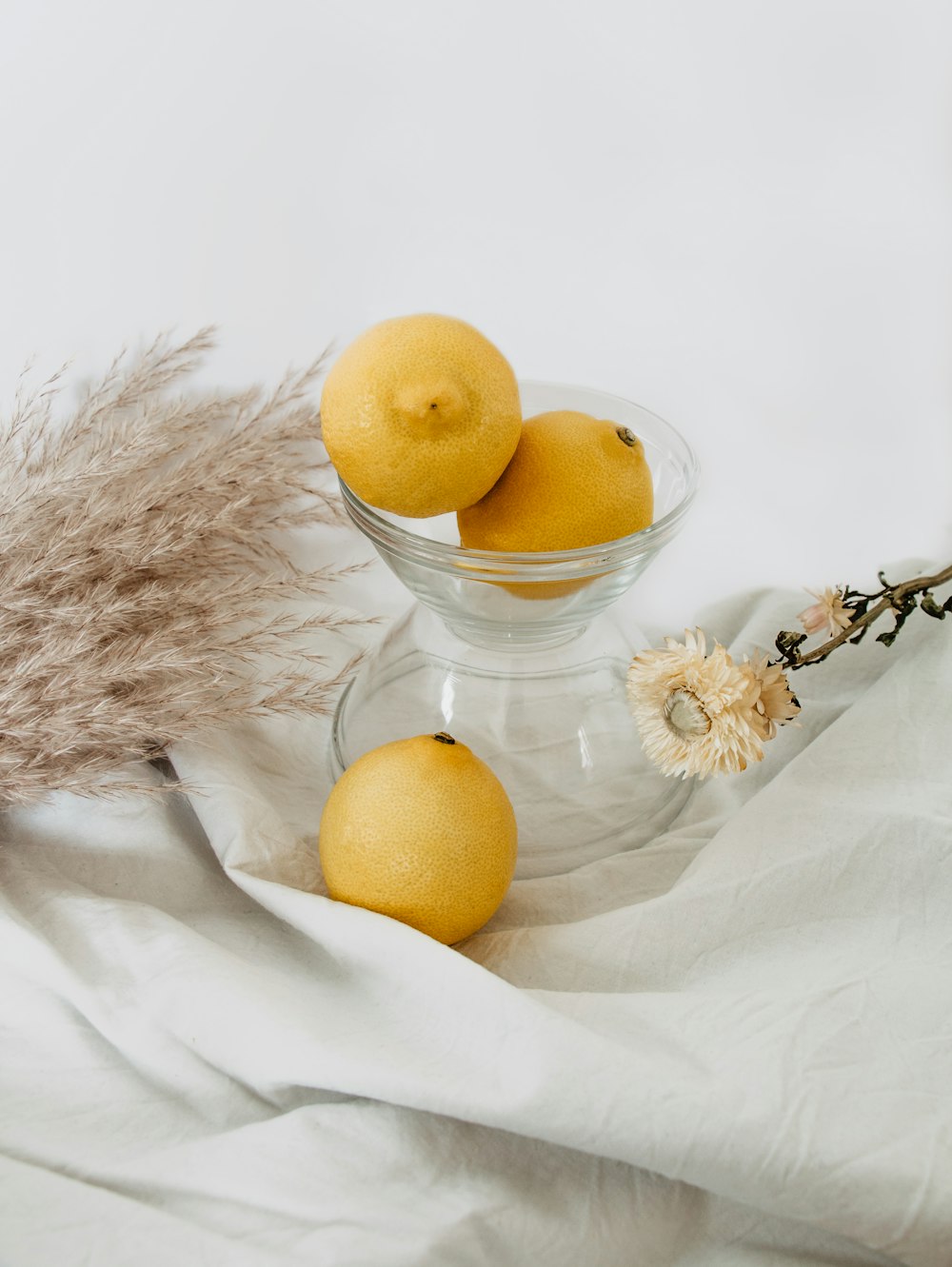 yellow lemon fruit on white textile