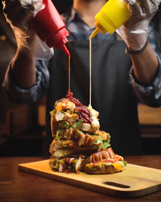 person holding red and yellow ice cream cone