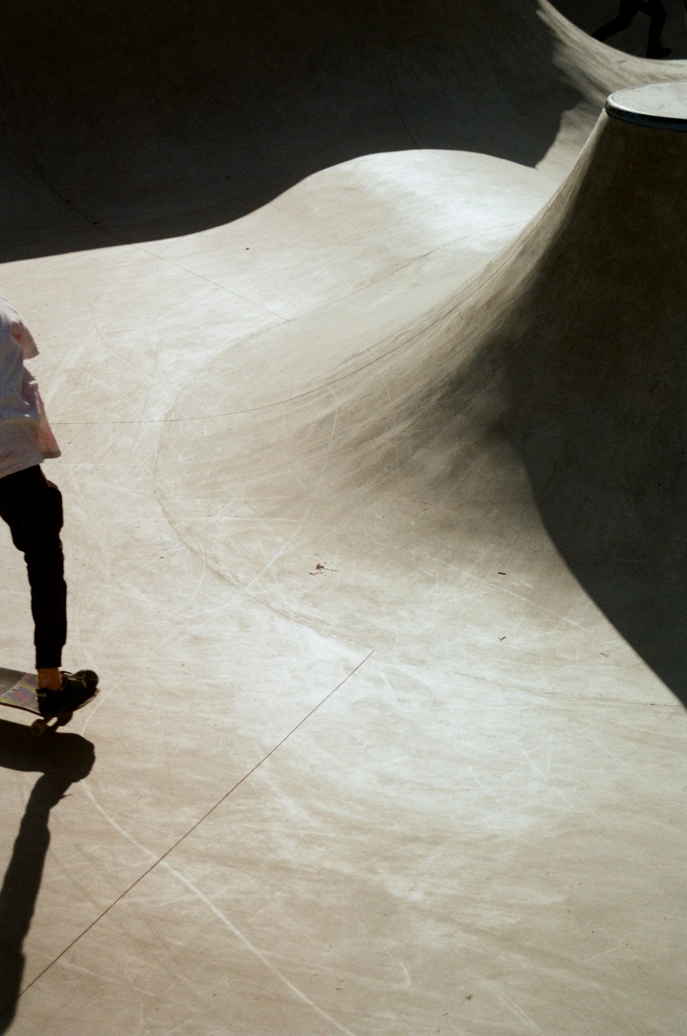 girl in pink shirt and black pants walking on white floor tiles