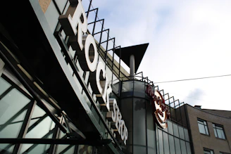 A friendly small business owner in Asaba happily reviewing loan documents with a Power Rock representative.