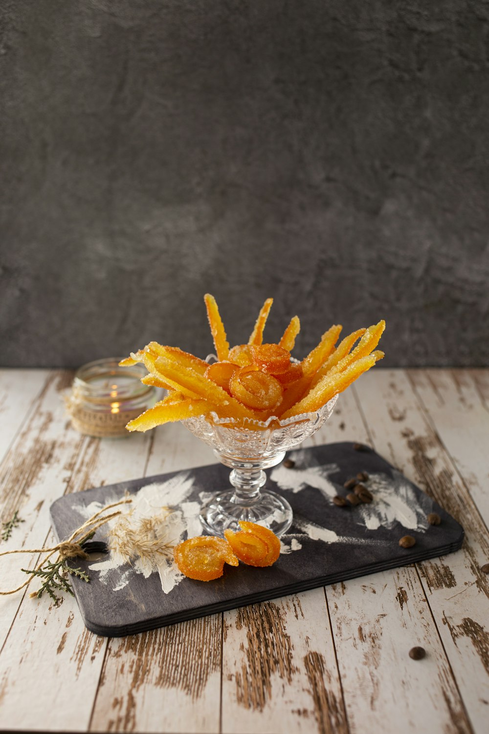 yellow flower in clear glass vase on white table