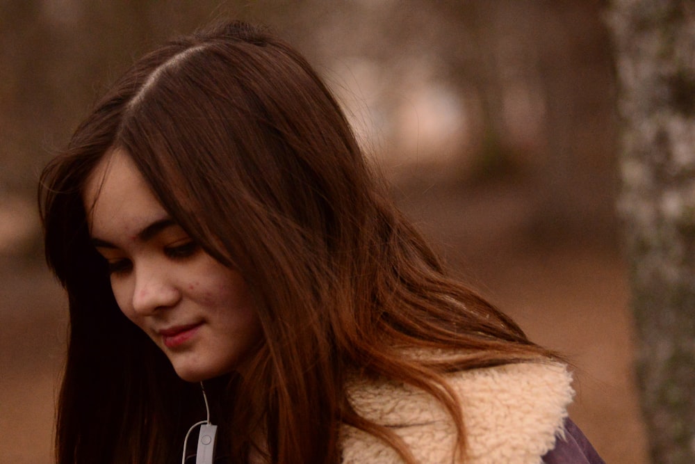 woman in white sweater with white earbuds