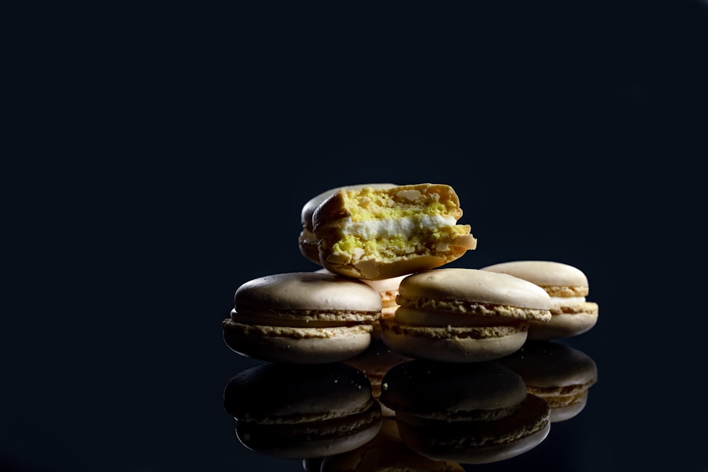 brown and white cookies on black surface