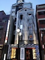 Facade of a contemporary hotel featuring elegant stone and glass work.