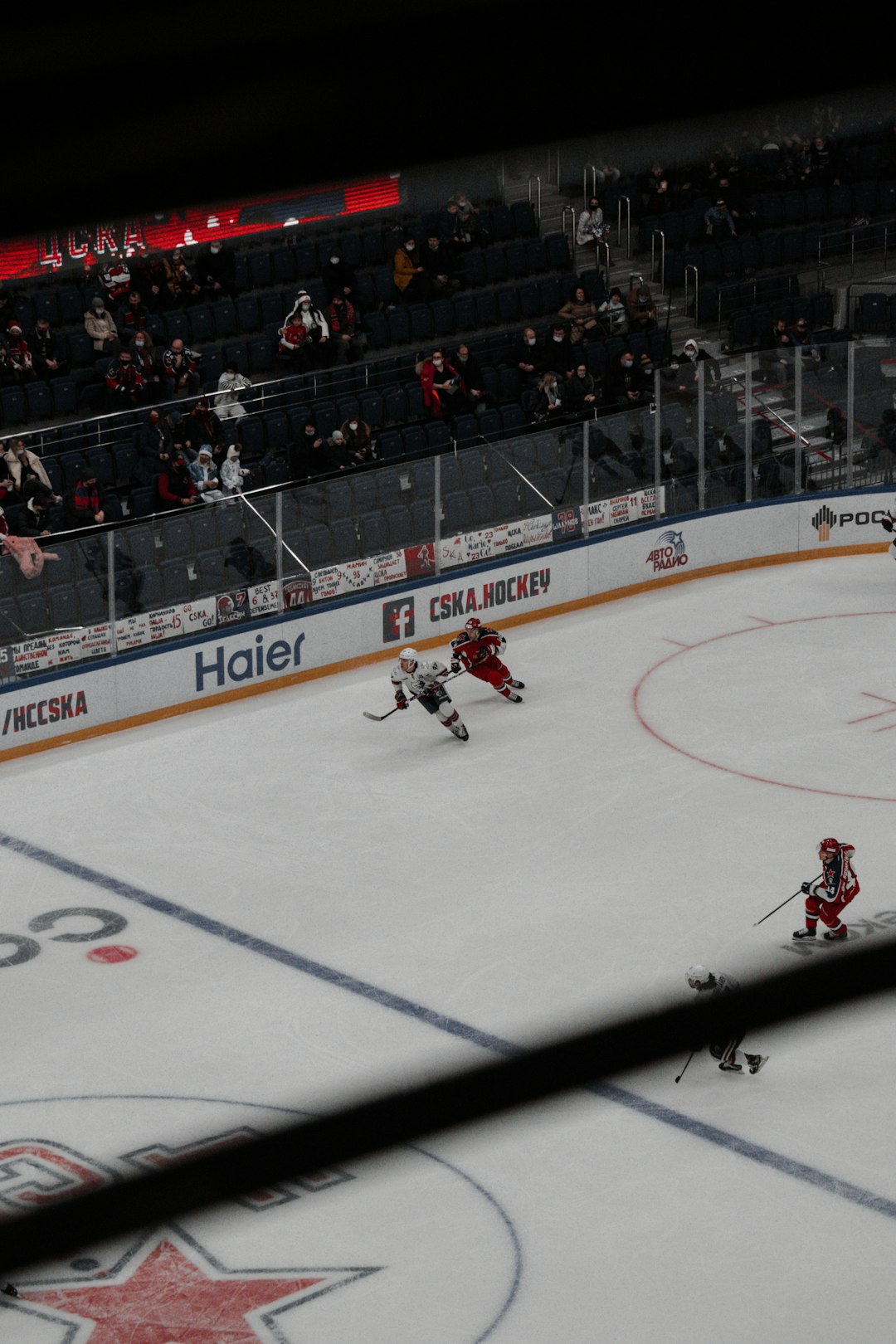 people playing ice hockey inside stadium