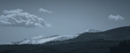 Snow-capped peaks of the Himalayas seen from a peaceful hill station in North India.