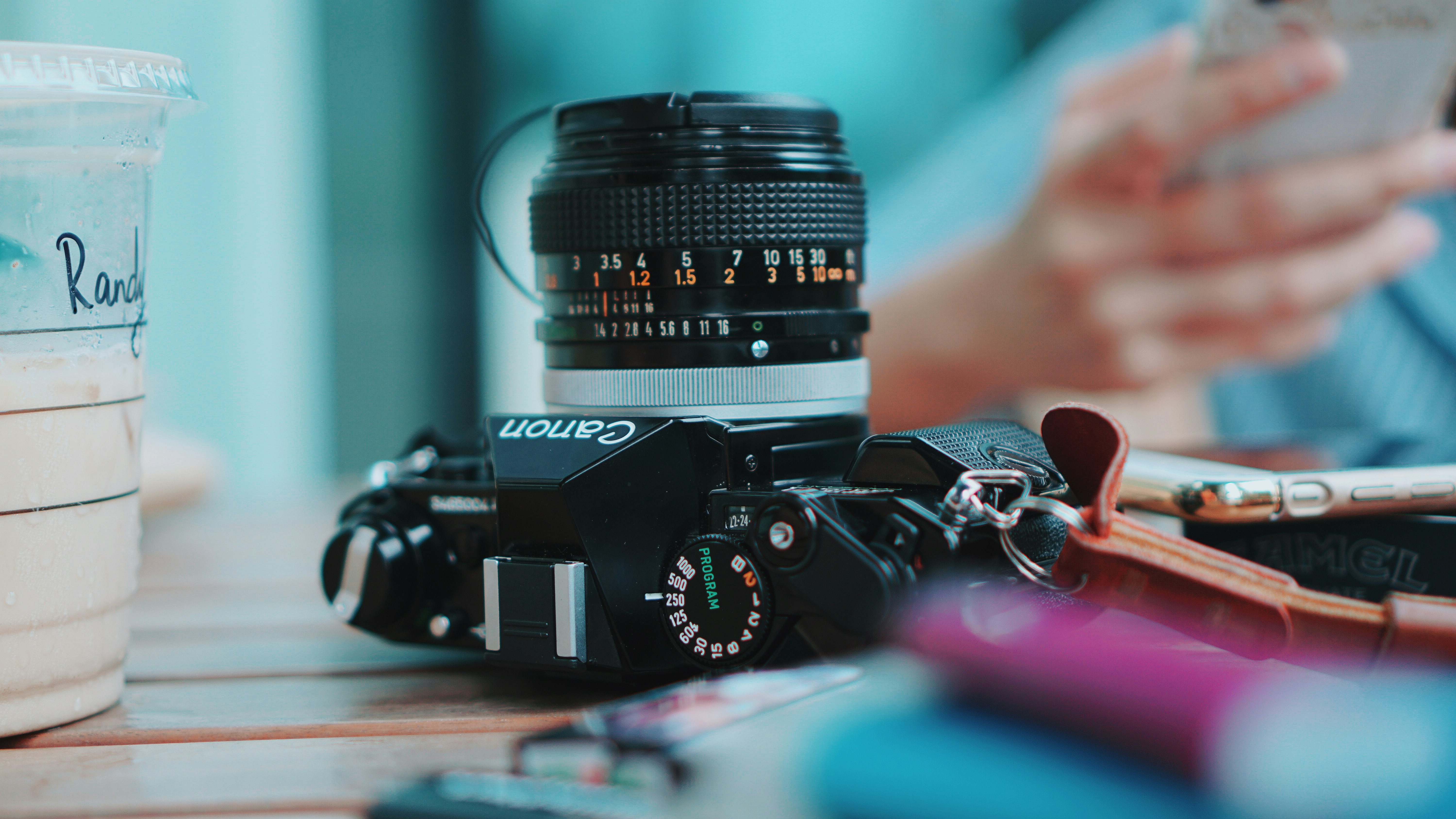 black nikon dslr camera on brown wooden table