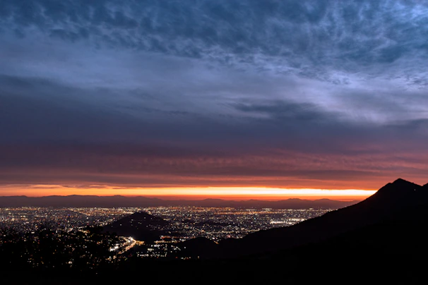 A panoramic view of a vibrant Middle Eastern city skyline at sunset.