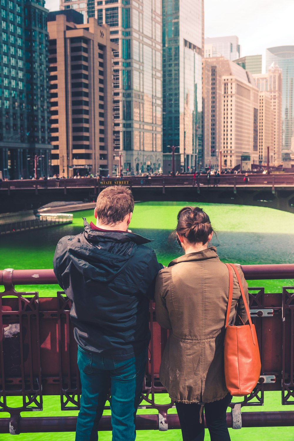 man and woman standing on green field during daytime