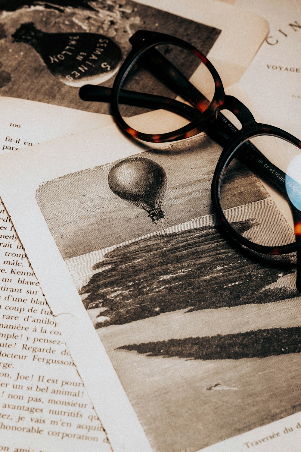 black and red framed eyeglasses on white printer paper