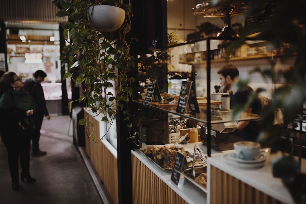 woman in white shirt standing near counter