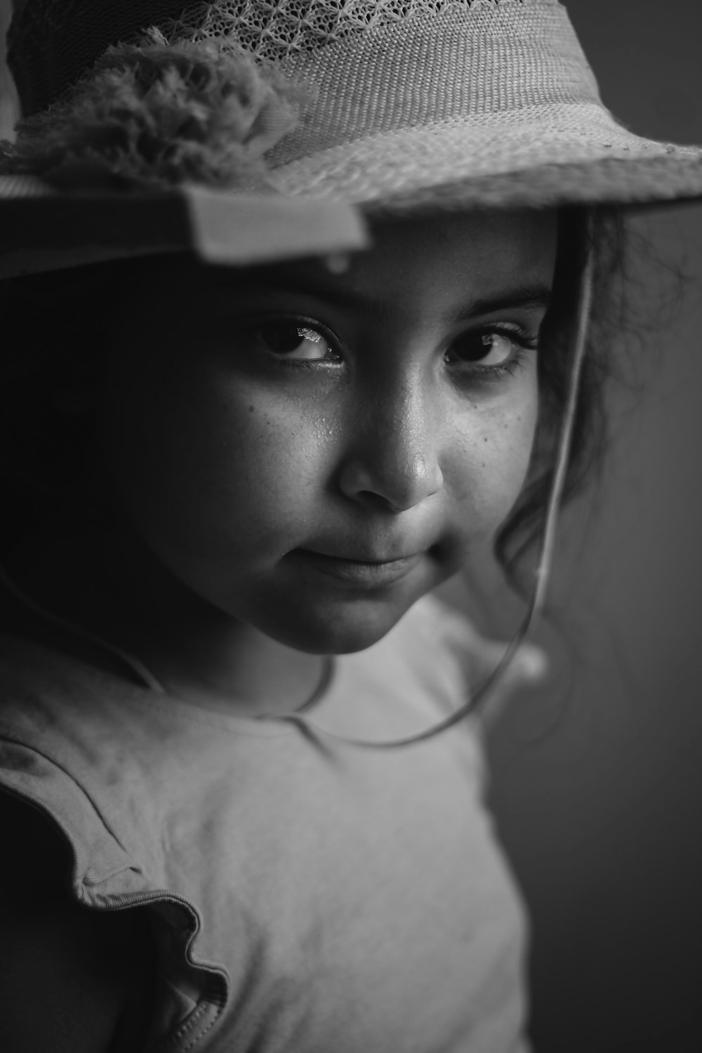 grayscale photo of woman wearing white hat