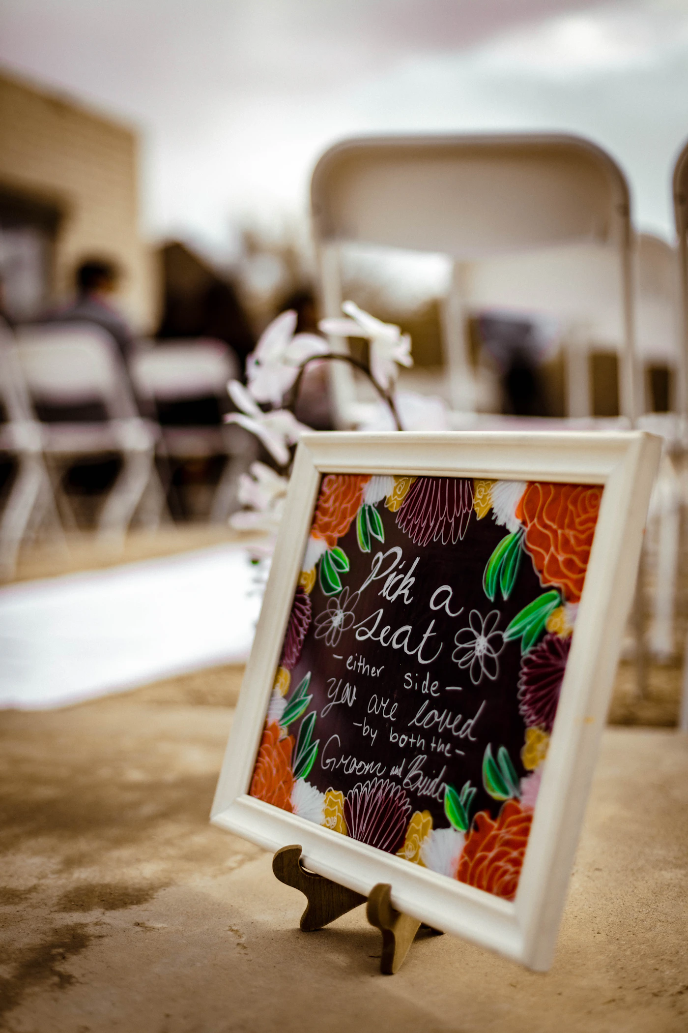Wedding reception seating charts for blended families — A blended family sharing a meal and laughing at a wedding reception table.