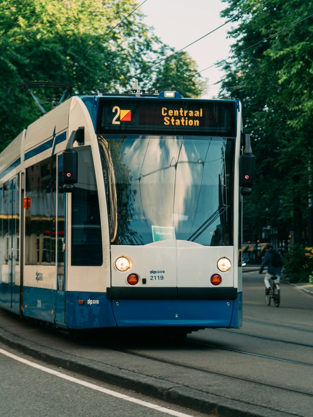 white and blue tram on road during daytime