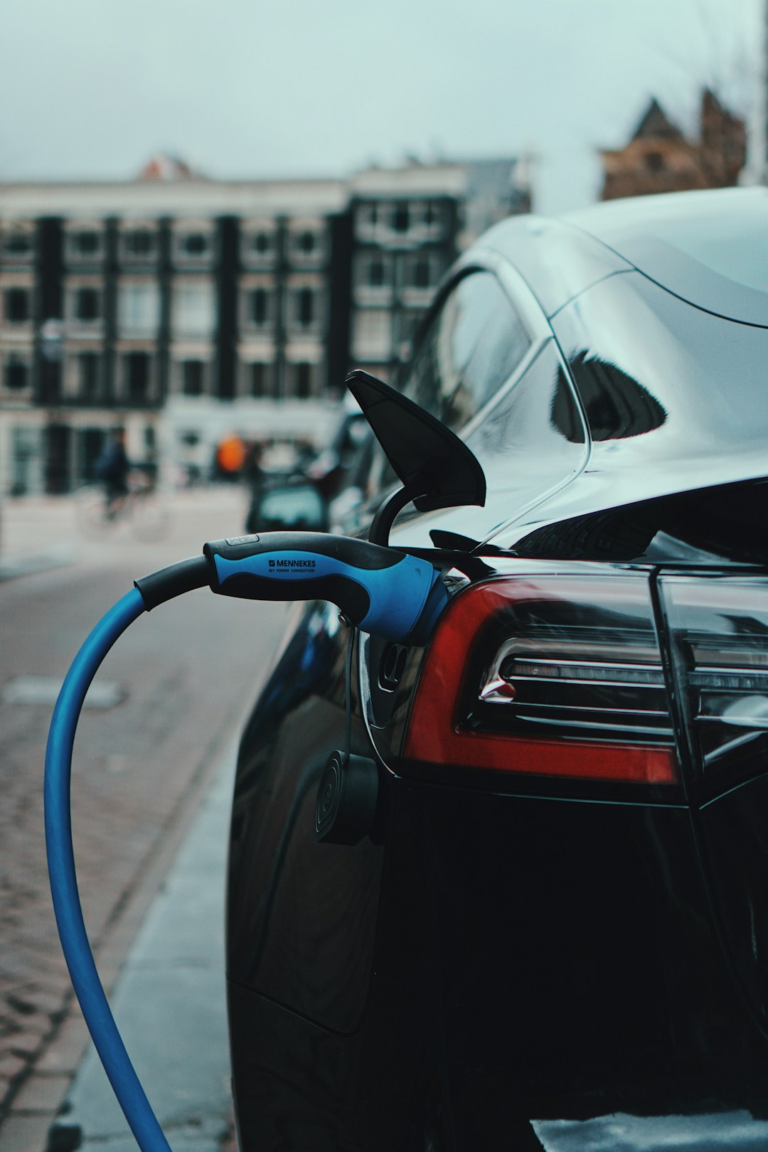 Electric car charging on a city street