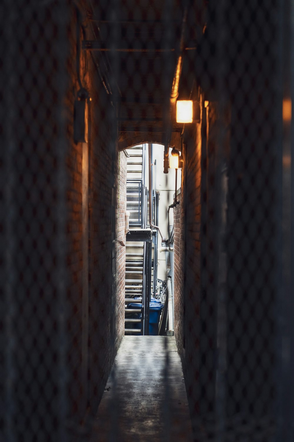 brown brick hallway with blue metal railings