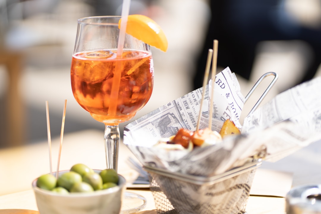 clear wine glass with orange liquid,