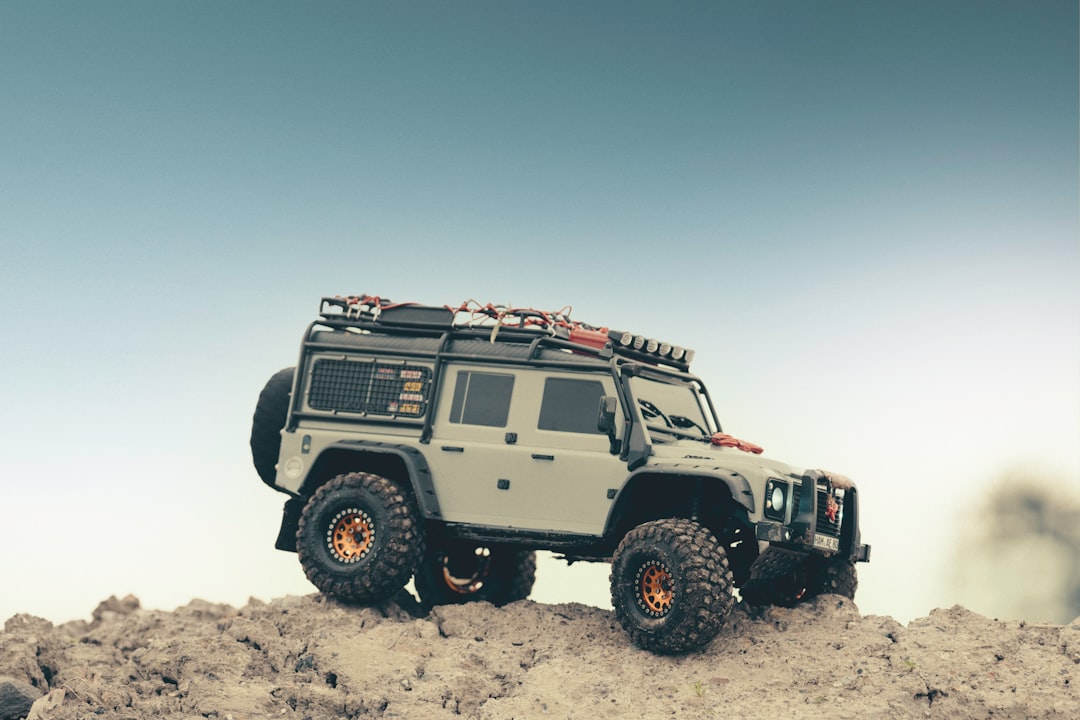 white and black jeep wrangler on white sand during daytime