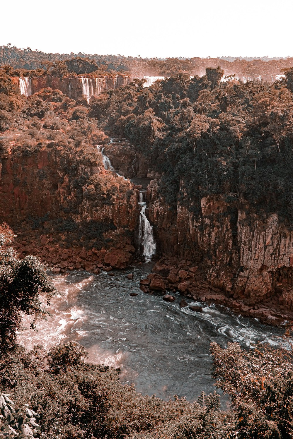 brown and green mountain beside river during daytime