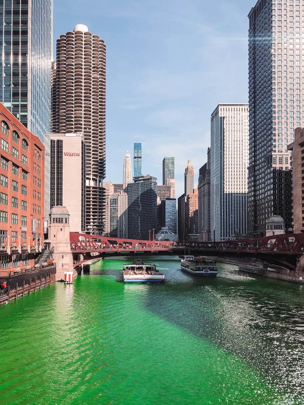 body of water between high rise buildings during daytime