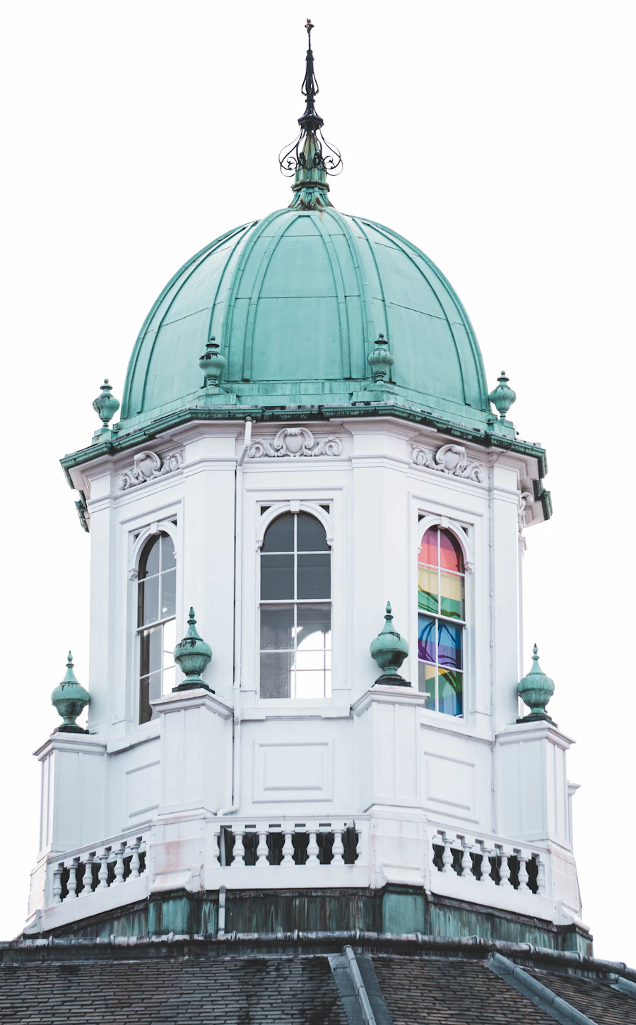 A white cupola with a green copper dome