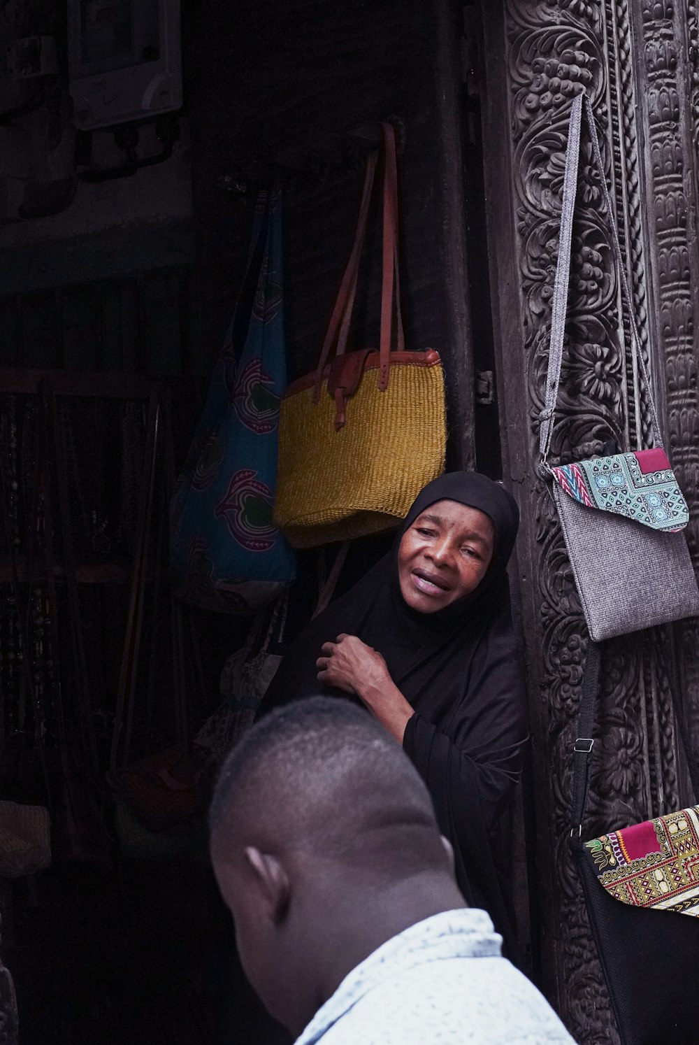 woman in black hijab sitting beside man in black thobe