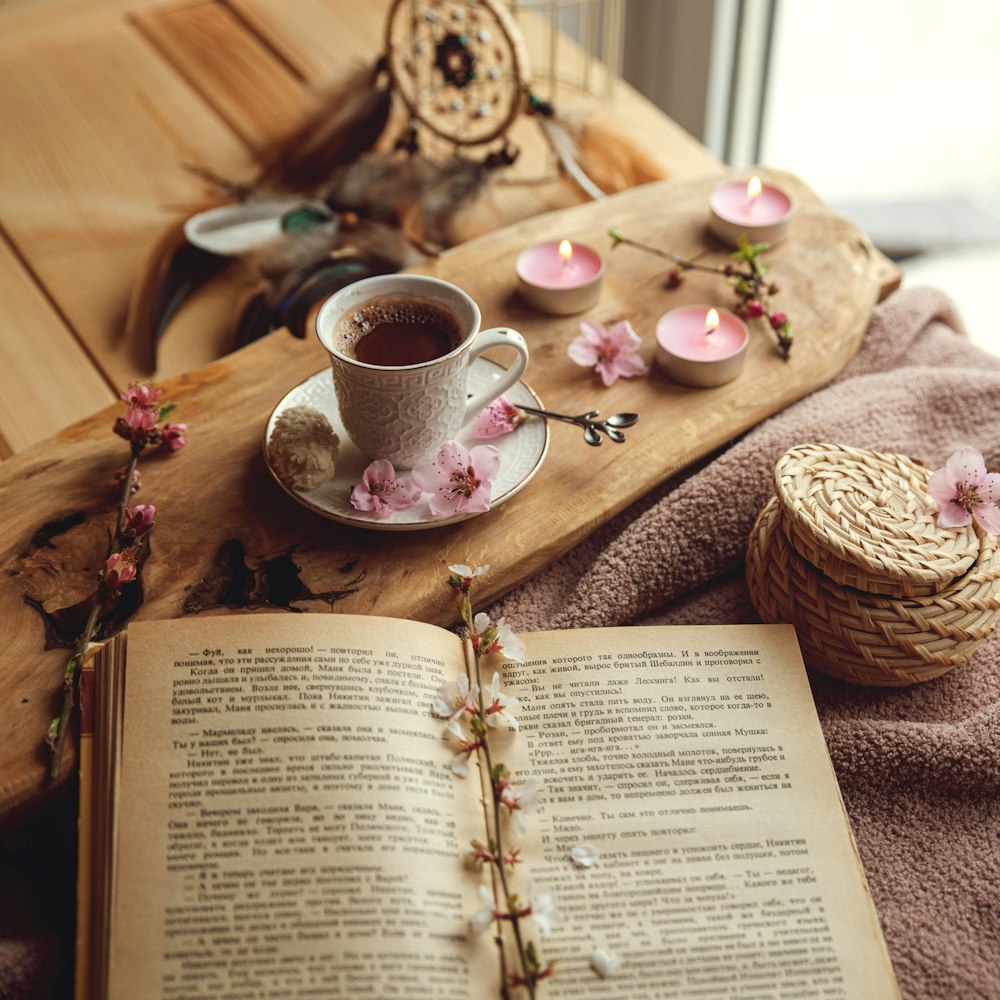 white ceramic teacup on book page