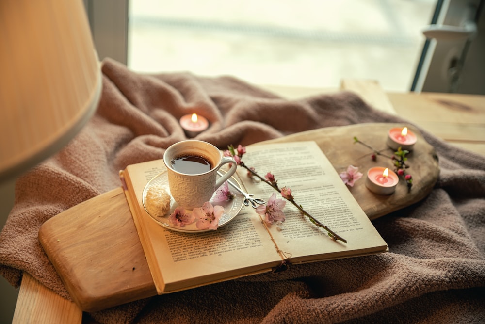 white ceramic mug on book page