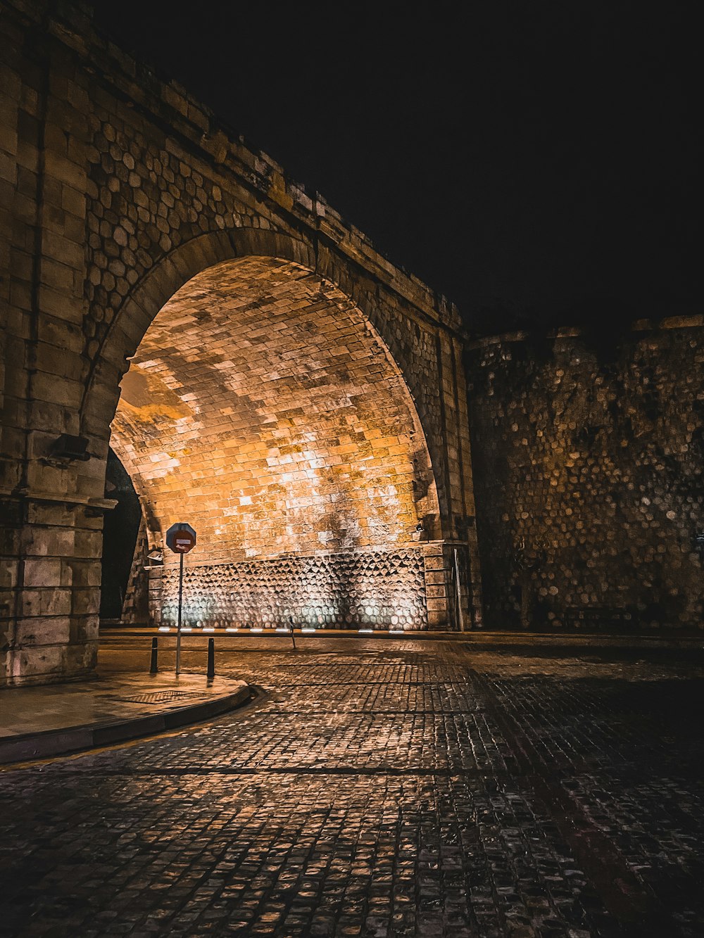 brown brick tunnel with light