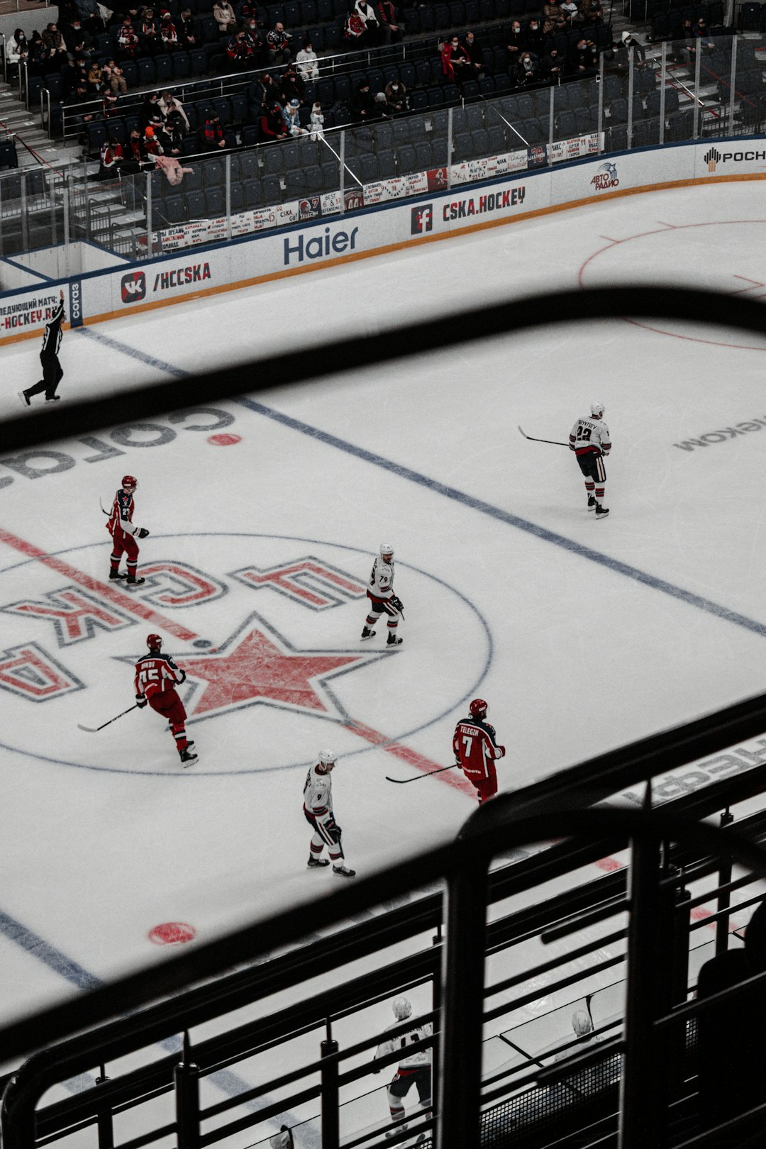 people playing ice hockey on ice field