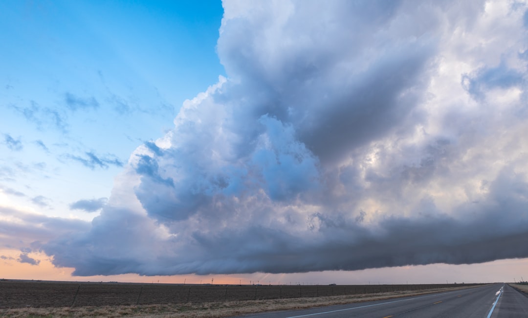 white clouds over brown field during daytime