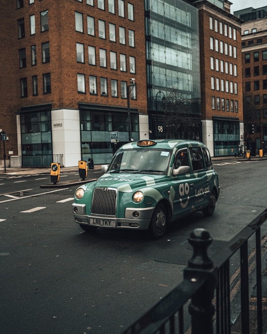 A friendly Leyton taxi driver assisting a passenger with luggage beside a clean, modern taxi.