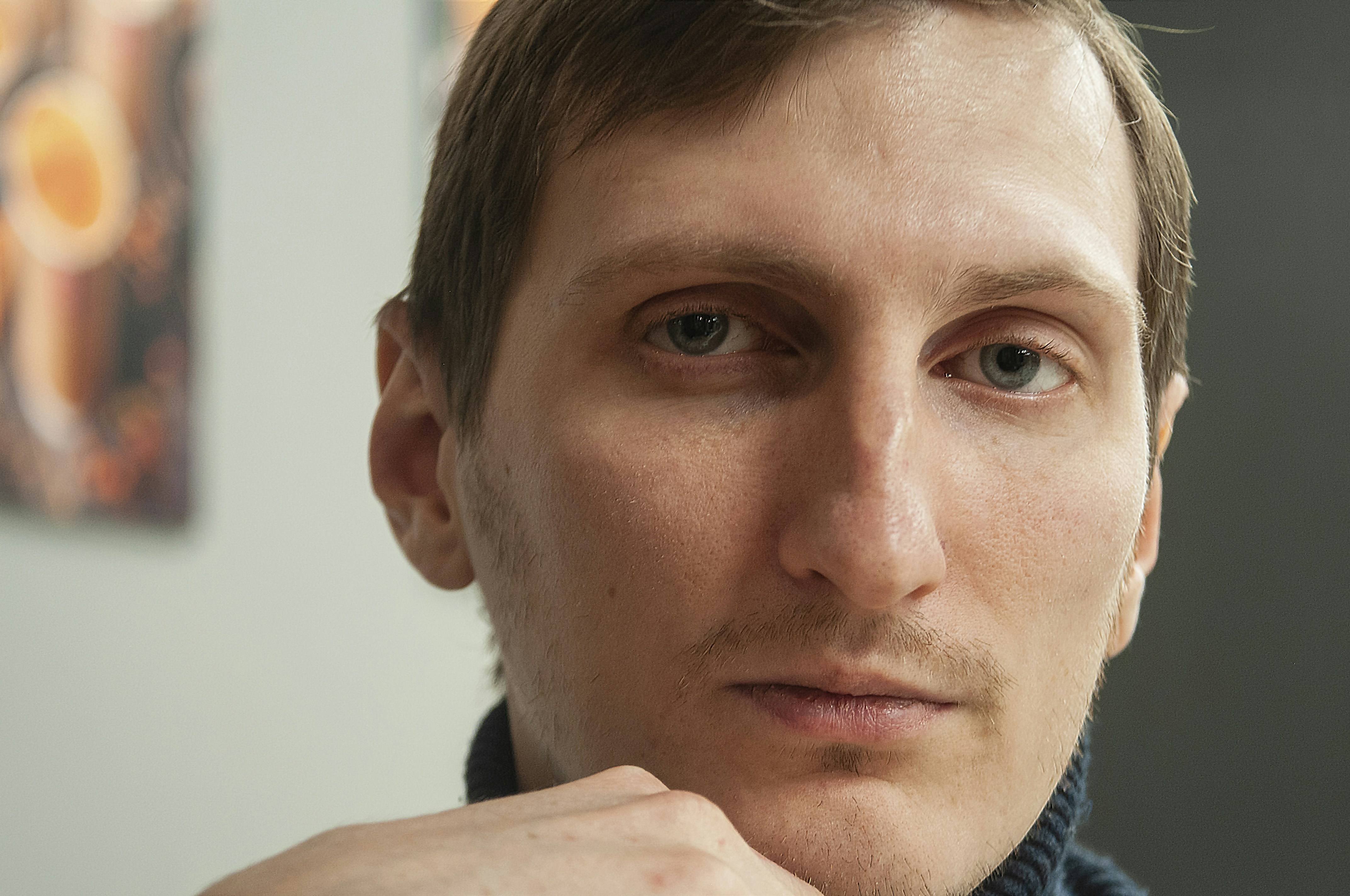 man in black and gray jacket weary teams background