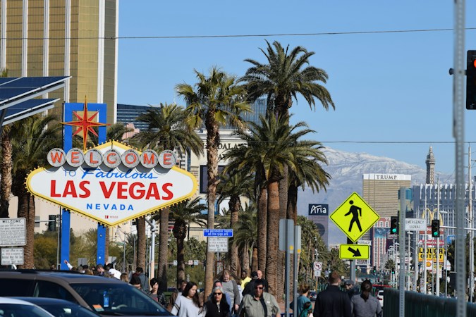 People walking along a downtown Las Vegas street in daytime, a short drive from the planned Foundry homes on Washington Avenue