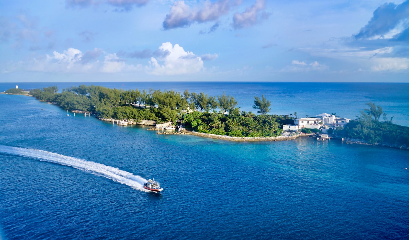 Aerial view of a small tropical island channel near Paradise Island, Nassau, Bahamas, with a boat leaving a wake