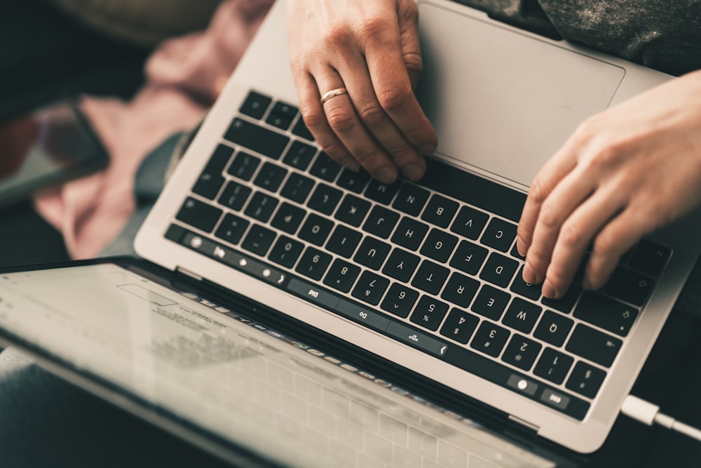 person using black and silver laptop computer