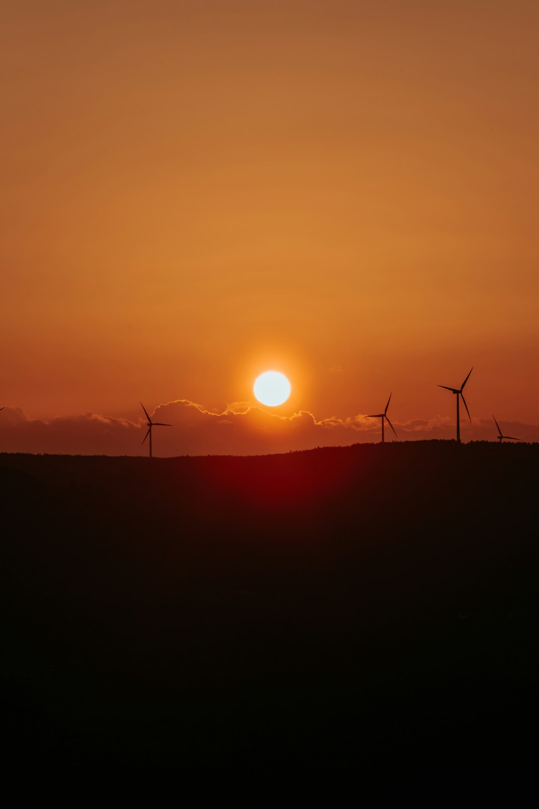 silhouette of a wind mill during sunset