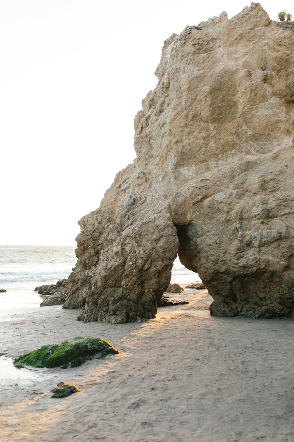 brown rock formation on beach during daytime