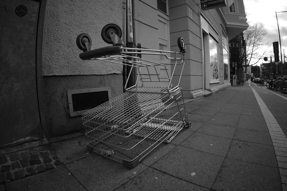 a shopping cart sitting on the side of a street